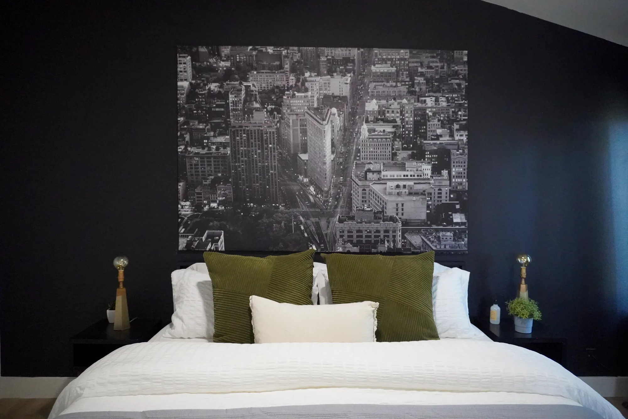 Primary bedroom with city skyline art