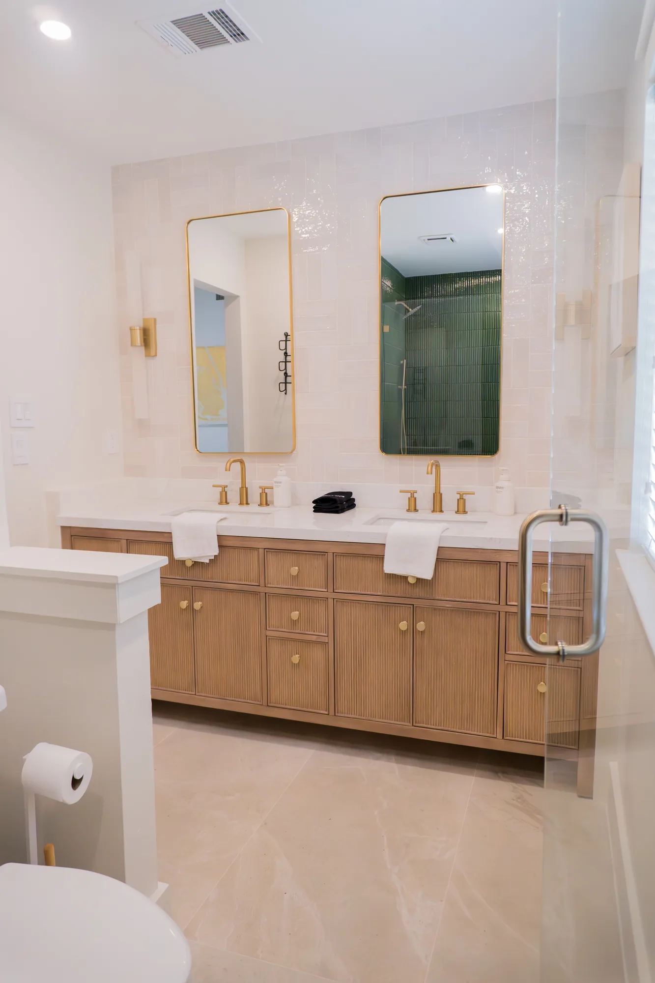 Primary bath double vanity with gold fixtures